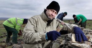 A group building a dry stone wall