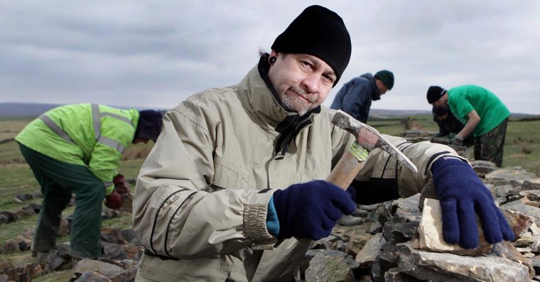 A group building a dry stone wall